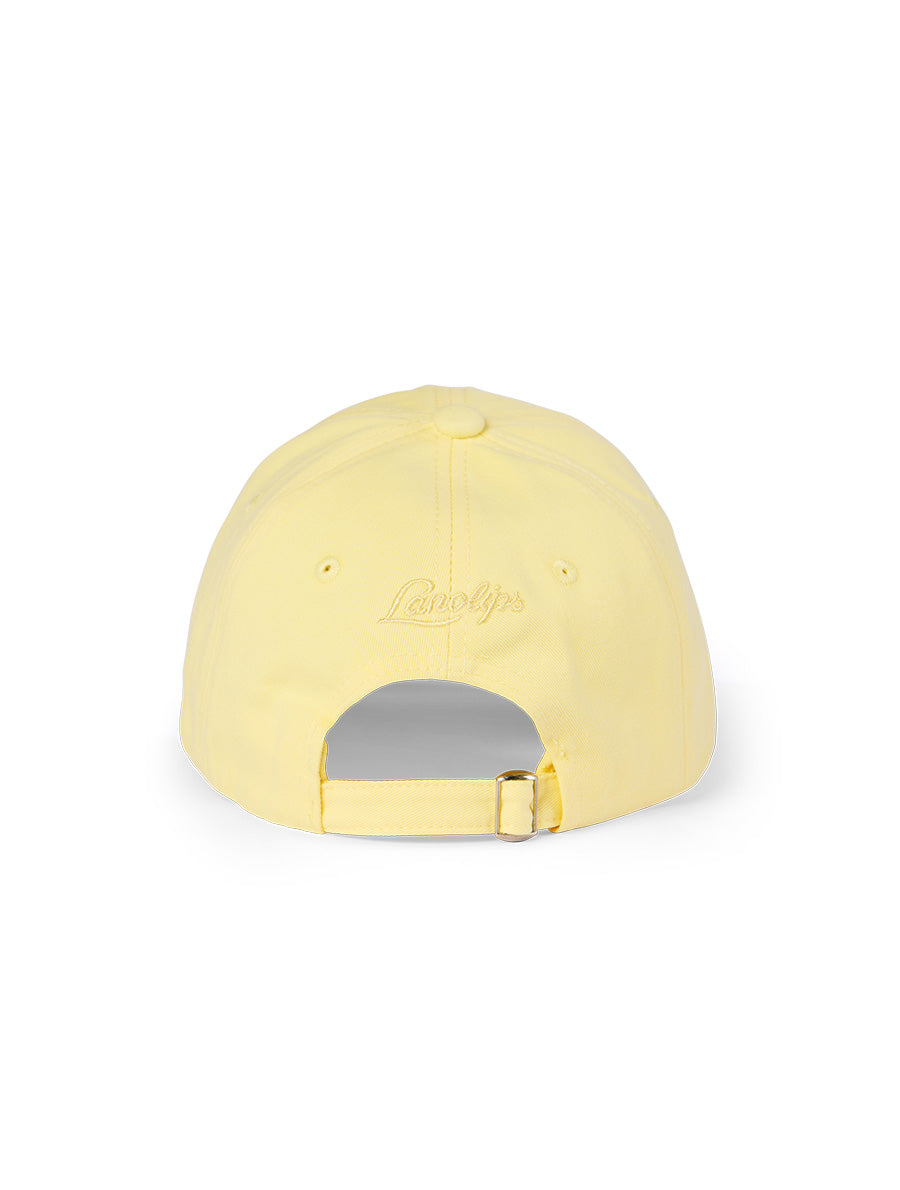 Lanolips Go Bananas Yellow Cap showcases a back view with an adjustable slider fastening, allowing you to easily customise the fit for most head sizes. The cap also features the iconic Lanolips logo on the back, adding a touch of brand flair to your style.