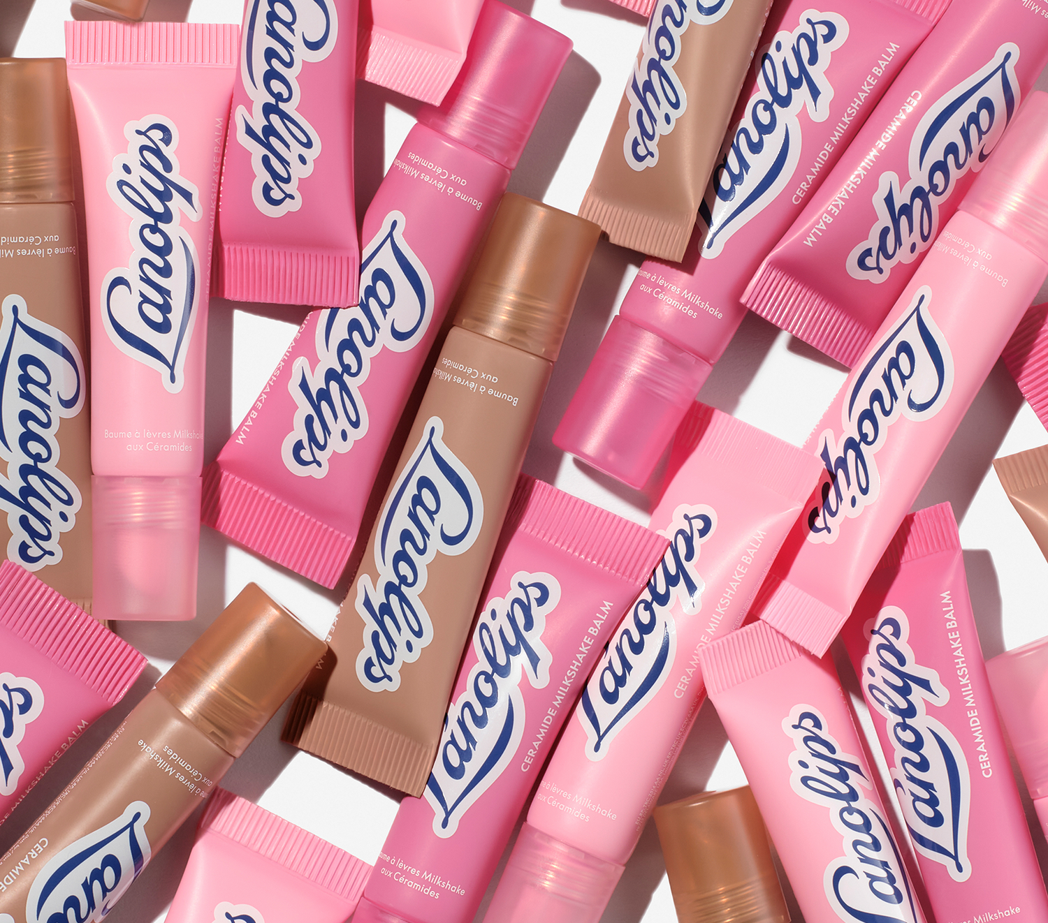 Lanolips ceramide milkshake mini balms lip balm tubes in pink and brown packaging on a white background.