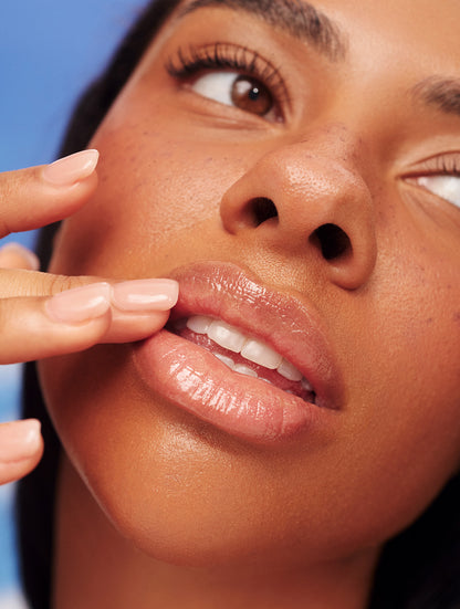 Close-up of glossy, hydrated lips after applying Lanolips Sun Balm SPF 30 Tropical - nourishing, SPF-protected shine with a smooth, radiant finish.
