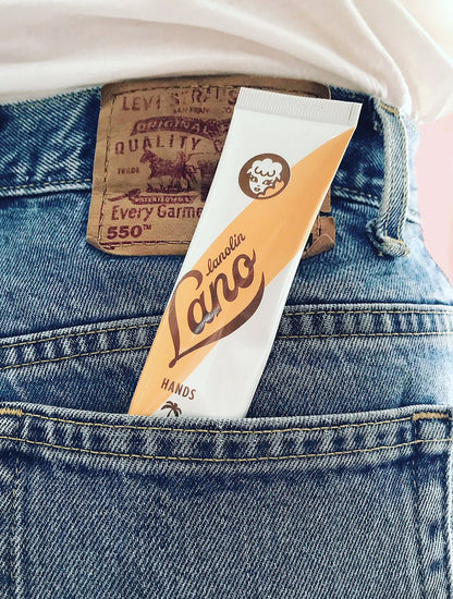 Lanolips coconutter hand cream intense tube sticking out of a jeans pocket.
