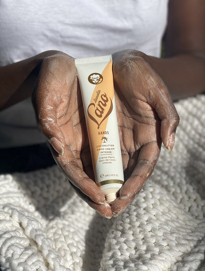 Model shot holding a lanolips coconutter hand cream intense tube in her hands